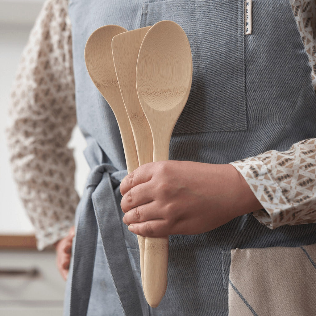 Natural Organic Bamboo Cooking Utensils, set of three, being held in a hand