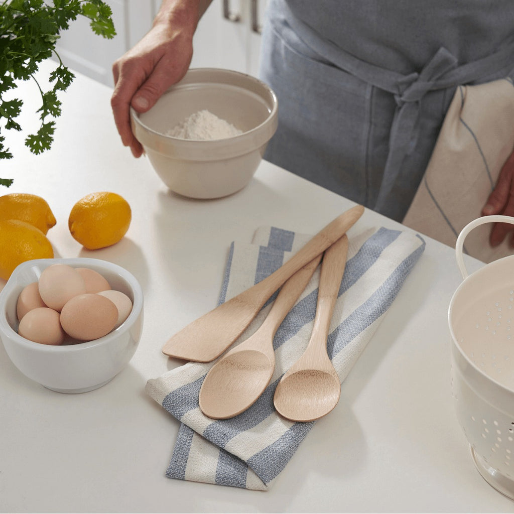 Natural Organic Bamboo Cooking Utensils, set of three, shown in a kitchen.